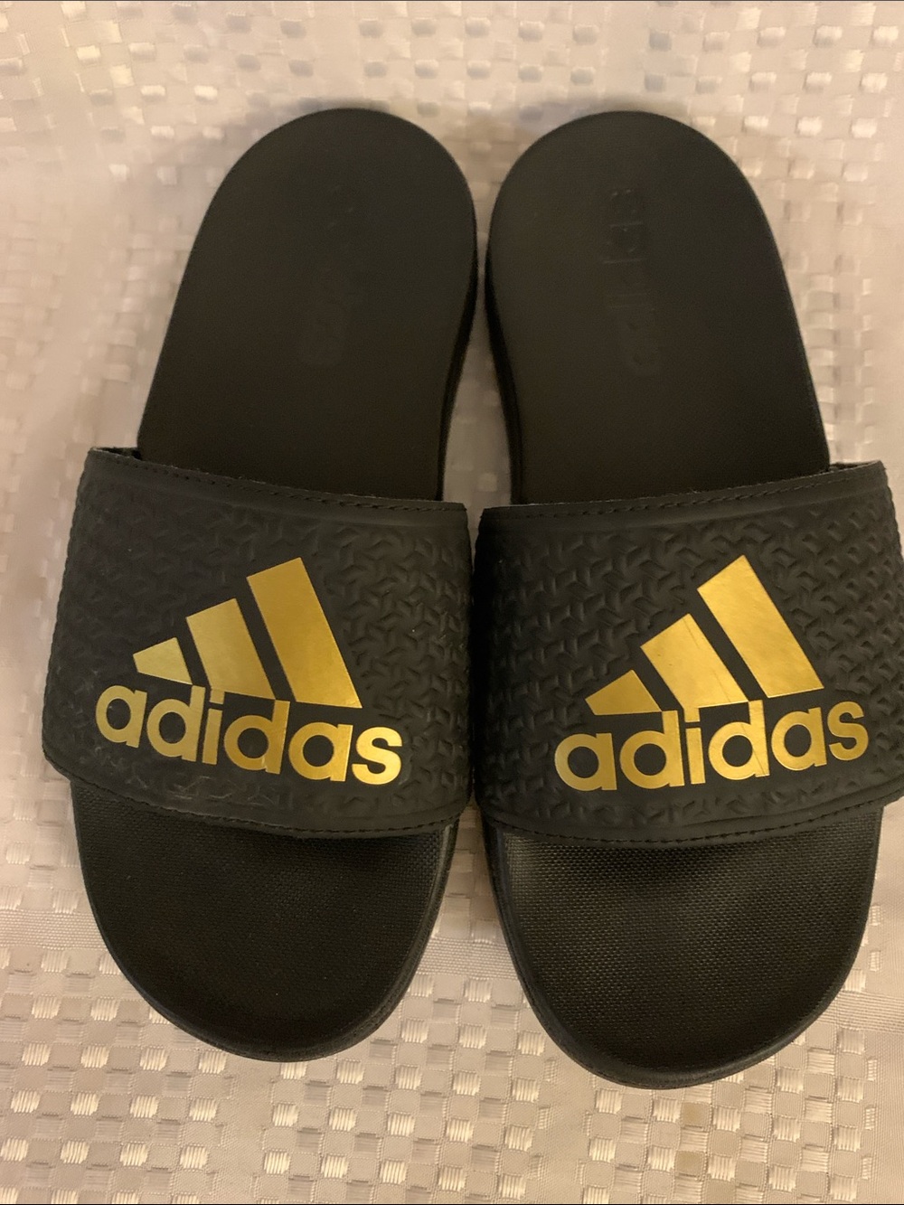 Adidas kids black and gold slide sandals, size 2.